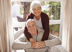 A senior couple smiles as they have realized that home care is best for them.